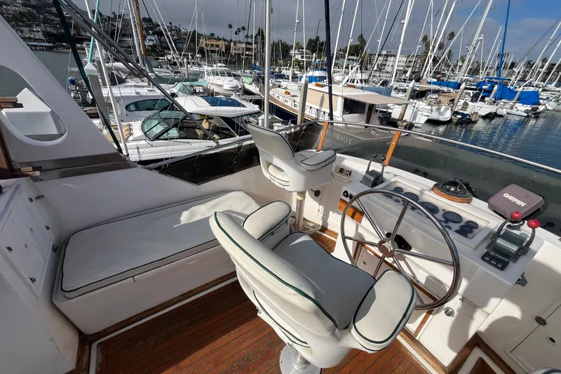 Slide: The Image of 1984 Tung Hwa Princess Aft Cabin yacht helm with marina view, featuring steering wheel and controls. - 11