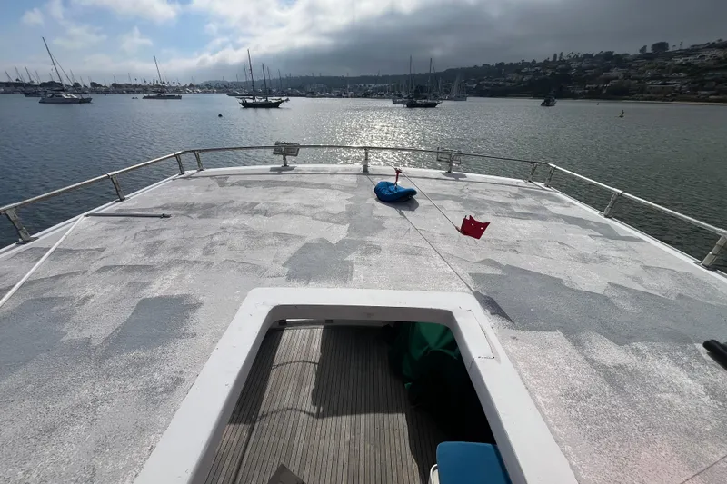 Slide: The Image of 1984 Tung Hwa Princess Aft Cabin yacht deck overlooking a serene harbor with moored boats. - 15