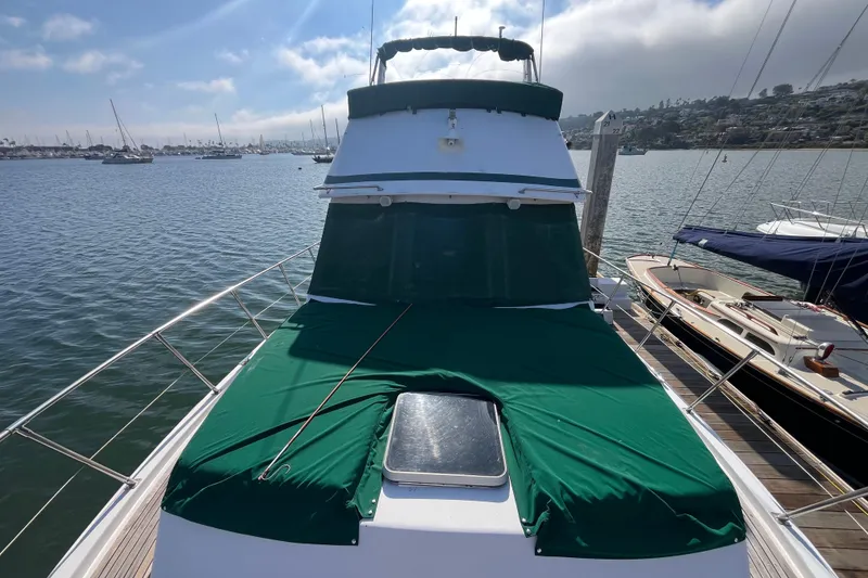 Slide: The Image of 1984 Tung Hwa Princess Aft Cabin yacht docked, featuring green covers and scenic marina view. - 2