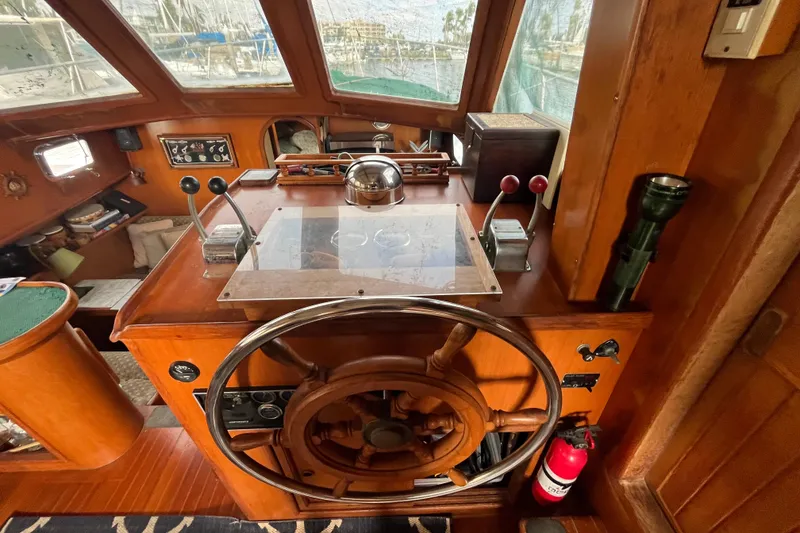 Slide: The Image of 1984 Tung Hwa Princess Aft Cabin helm with wooden wheel and navigation controls. - 20