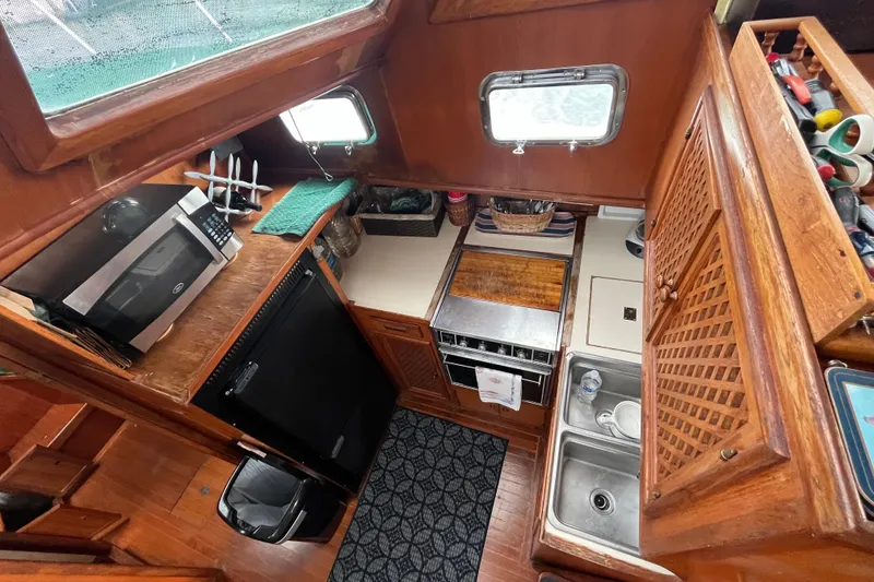 Slide: The Image of 1984 Tung Hwa Princess Aft Cabin kitchen with wood cabinetry and modern appliances. - 24