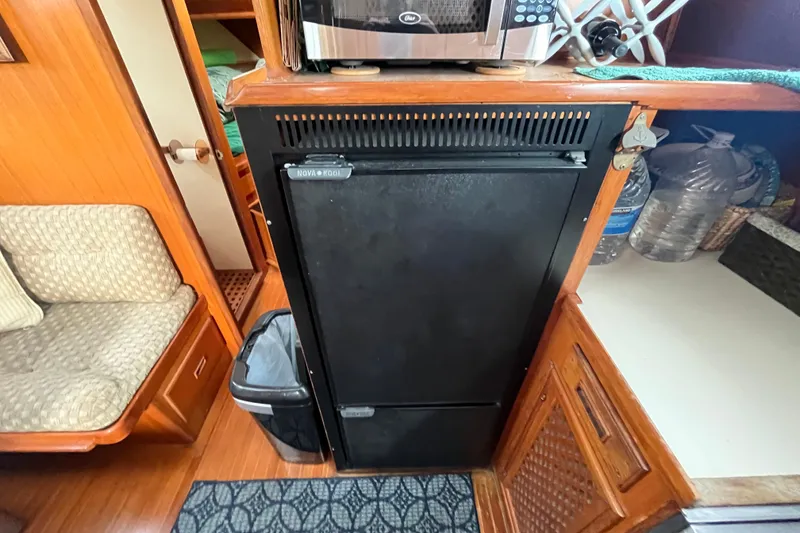 Slide: The Image of 1984 Tung Hwa Princess Aft Cabin interior with fridge, microwave, and seating area. - 26