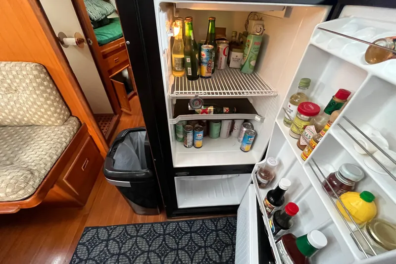 Slide: The Image of 1984 Tung Hwa Princess Aft Cabin interior with stocked fridge and cozy seating area. - 27