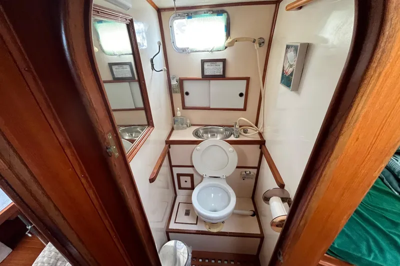 Slide: The Image of 1984 Tung Hwa Princess Aft Cabin bathroom with wooden accents and compact design. - 34