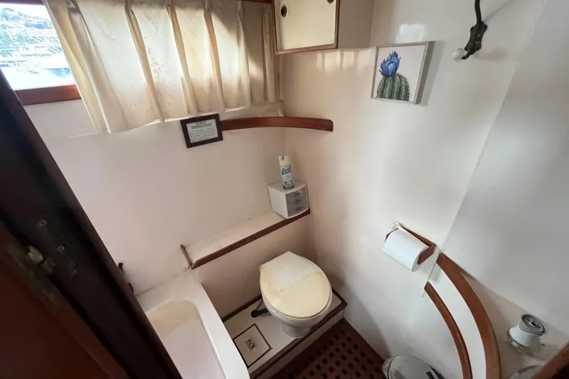 Slide: The Image of 1984 Tung Hwa Princess Aft Cabin bathroom with toilet, sink, and nautical decor. - 40