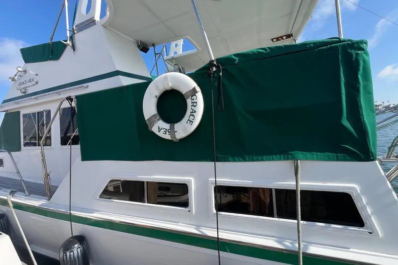 Slide: The Image of 1984 Tung Hwa Princess Aft Cabin yacht with green covers and life preserver. - 5