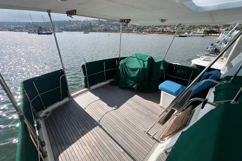 Slide: The Image of 1984 Tung Hwa Princess Aft Cabin yacht deck with green covers and scenic harbor view. - 7