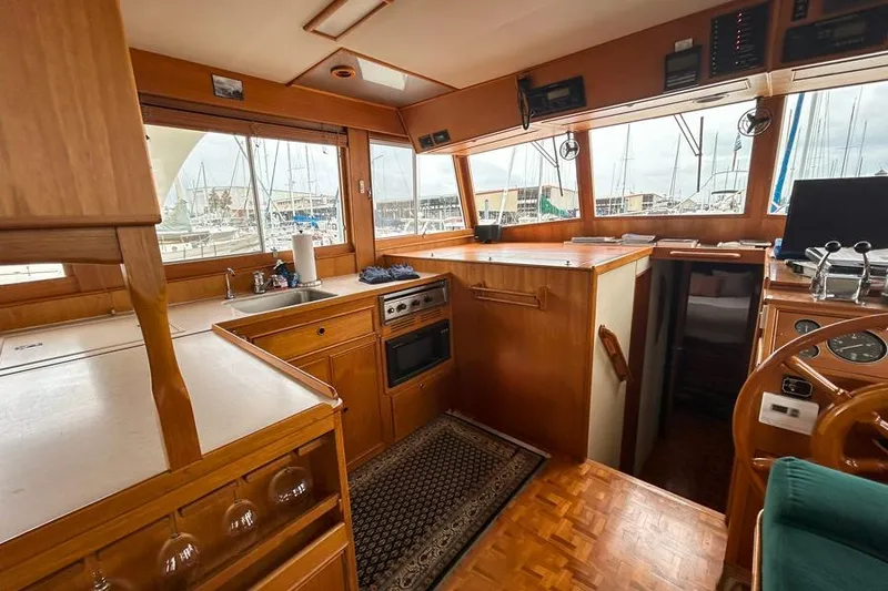 Slide: The Image of Interior of 1998 Grand Banks 46 Europa yacht with wooden cabinetry and nautical decor. - 12