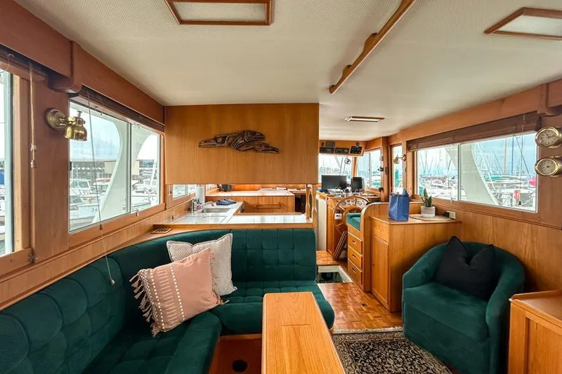 Slide: The Image of Interior of 1998 Grand Banks 46 Europa yacht with elegant wood and green upholstery. - 13