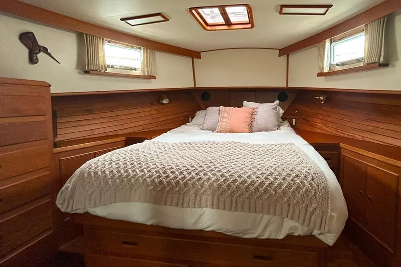 Slide: The Image of Cozy cabin interior of 1998 Grand Banks 46 Europa with wooden finish and comfortable bedding. - 6