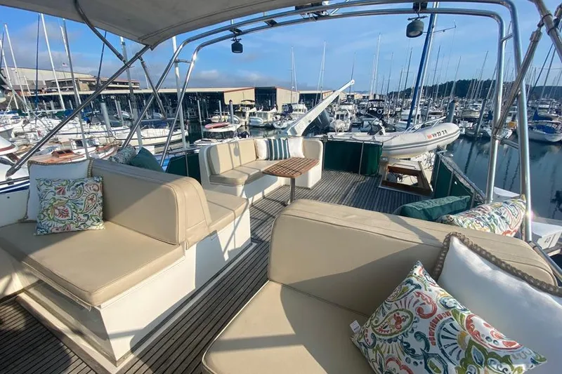 Slide: The Image of Spacious deck of 1998 Grand Banks 46 Europa yacht with comfortable seating and marina view. - 8