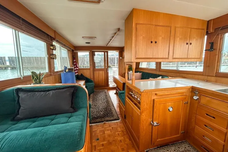 Slide: The Image of Interior of 1998 Grand Banks 46 Europa yacht with wood cabinetry and green seating. - 9