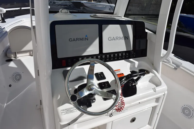 Slide: The Image of 2020 Sea Hunt Gamefish 27 helm with dual Garmin displays and steering wheel. - 10