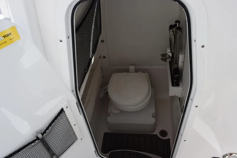 Slide: The Image of 2020 Sea Hunt Gamefish 27 boat interior with compact marine toilet. - 19