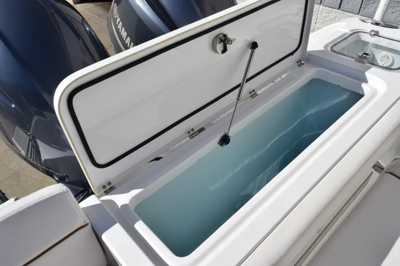 Slide: The Image of Open storage compartment on 2020 Sea Hunt Gamefish 27 boat, showcasing spacious interior. - 27