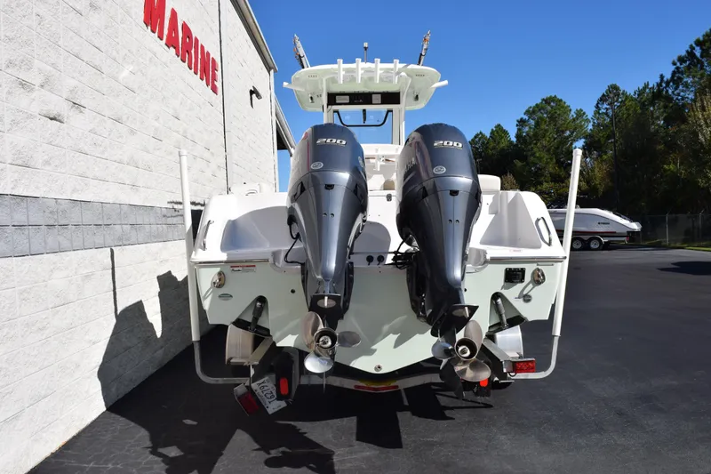 Slide: The Image of 2020 Sea Hunt Gamefish 27 with dual Yamaha 200 engines, parked outdoors. - 5