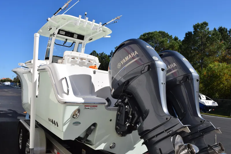 Slide: The Image of 2020 Sea Hunt Gamefish 27 with dual Yamaha engines on a trailer. - 6