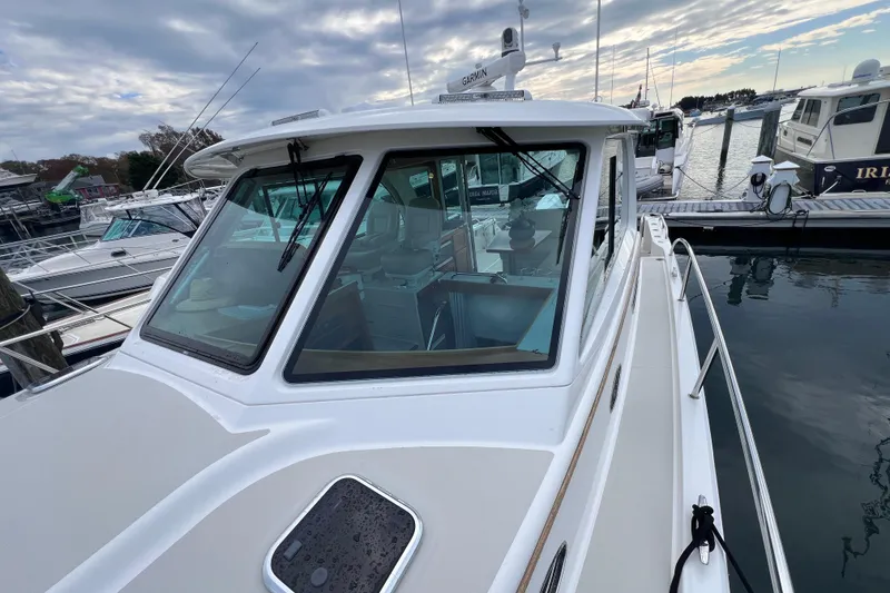 Slide: The Image of 2024 Back Cove 39O yacht docked at marina under cloudy sky. - 12