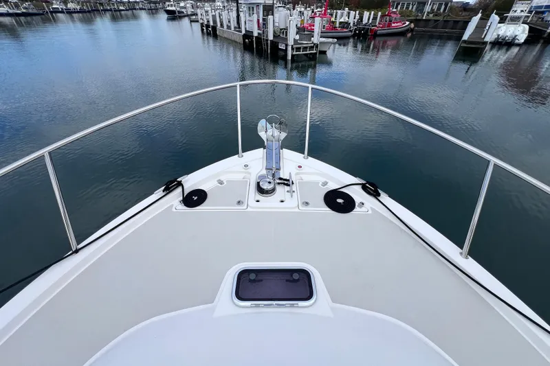 Slide: The Image of Bow view of 2024 Back Cove 39O yacht docked in a serene marina. - 13