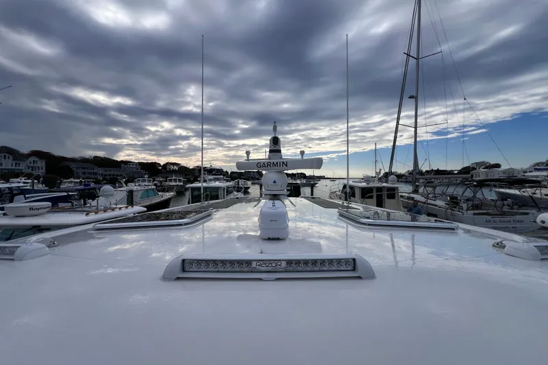 Slide: The Image of 2024 Back Cove 39O yacht docked in a marina under a cloudy sky. - 14