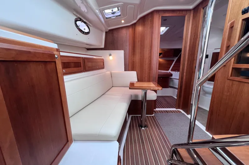 Slide: The Image of 2024 Back Cove 39O yacht interior with elegant wood finish and cozy seating area. - 18