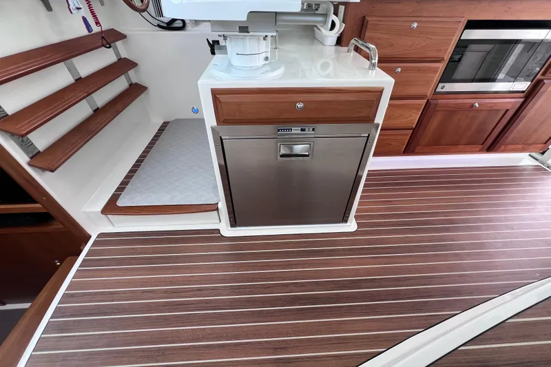 Slide: The Image of 2024 Back Cove 39O yacht interior with wood flooring and modern kitchen appliances. - 27