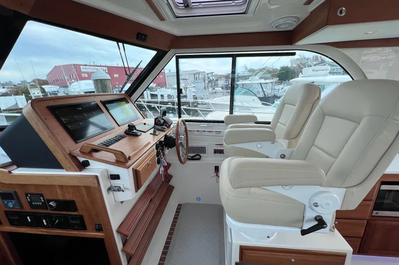 Slide: The Image of 2024 Back Cove 39O helm with dual seats and advanced navigation system. - 31
