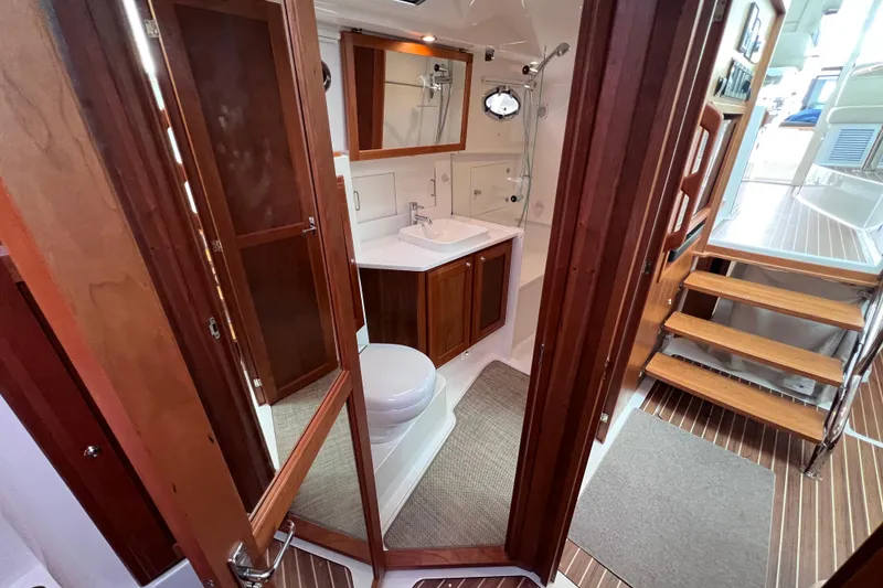 Slide: The Image of 2024 Back Cove 39O yacht interior with wooden cabinetry and modern bathroom. - 33