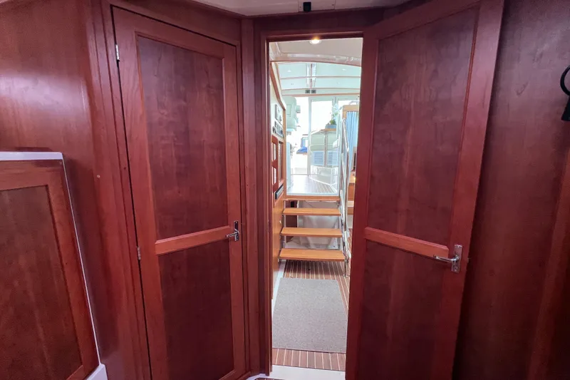 Slide: The Image of Interior view of 2024 Back Cove 39O yacht with wooden doors and staircase. - 34