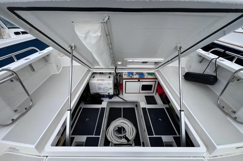 Slide: The Image of 2024 Back Cove 39O boat storage compartment with equipment and organized interior layout. - 4