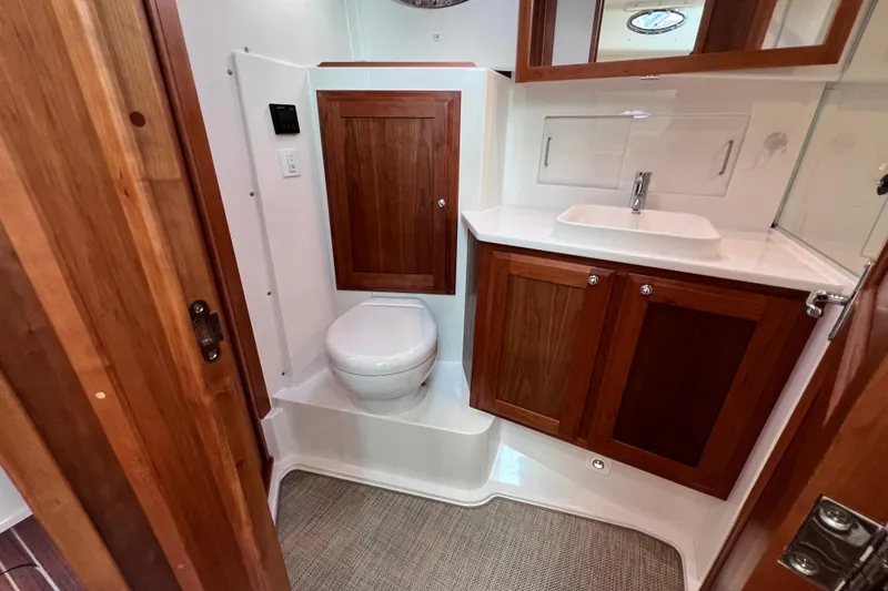 Slide: The Image of 2024 Back Cove 39O yacht bathroom with wooden cabinetry and modern fixtures. - 40