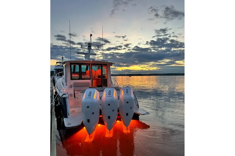 Slide: The Image of 2024 Back Cove 39O boat with triple engines at sunset on calm water. - 42
