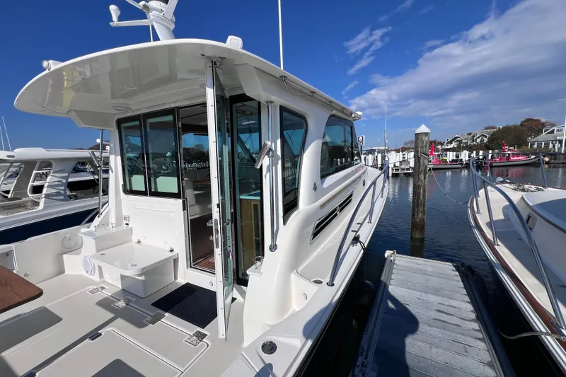 Slide: The Image of 2024 Back Cove 39O yacht docked at marina, showcasing sleek design and spacious deck. - 5