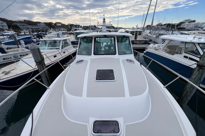 Slide: The Image of 2024 Back Cove 39O yacht docked at a marina, surrounded by other boats. - 9
