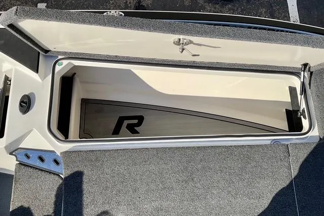 Slide: The Image of 2023 Ranger Z520R Ranger Cup Equipped boat storage compartment, open with visible interior. - 10