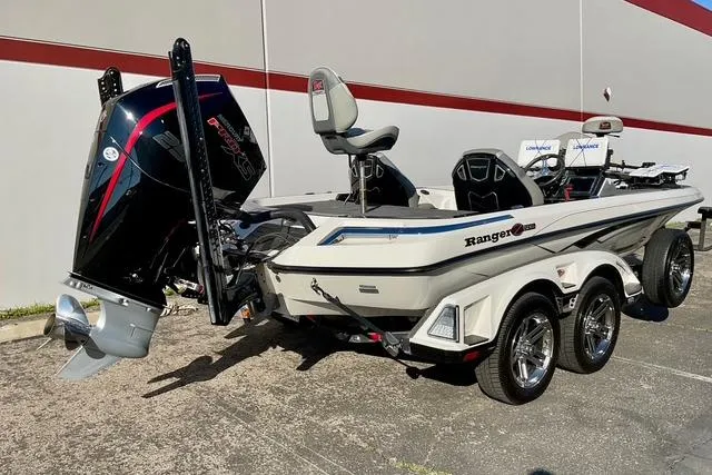 Slide: The Image of 2023 Ranger Z520R Ranger Cup Equipped boat with powerful outboard motor, parked outdoors. - 2