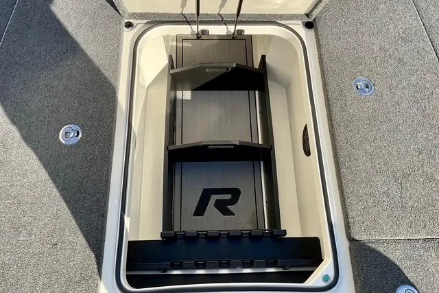 Slide: The Image of 2023 Ranger Z520R boat storage compartment with organized rod holders and sleek design. - 26