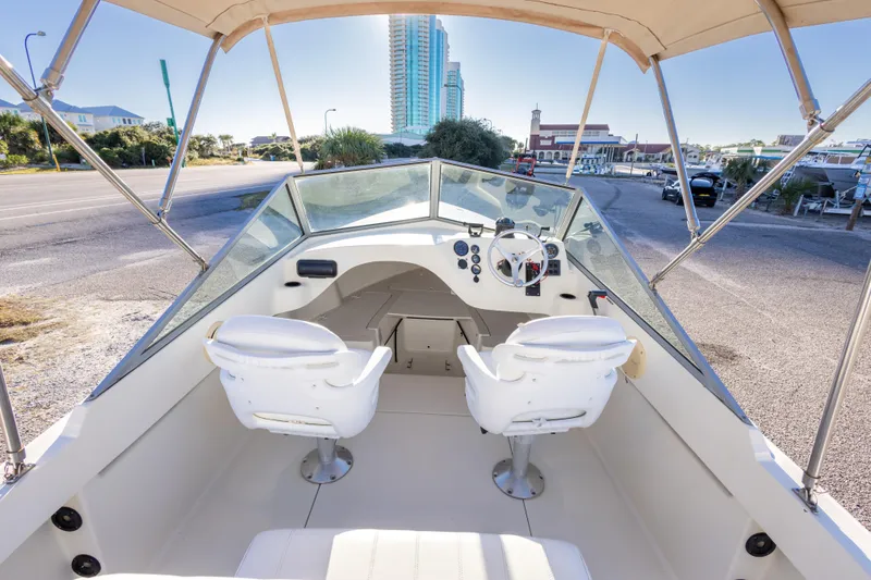 Slide: The Image of 2004 Hoby Pilot 19 boat interior with dual seats and steering wheel. - 21