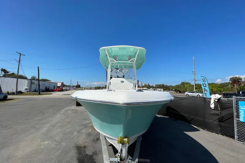 Slide: The Image of 2021 Clearwater 2200 boat on trailer under clear blue sky. - 10