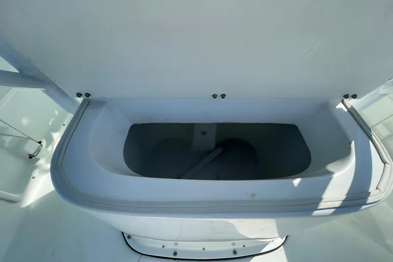 Slide: The Image of Open storage compartment on a 2021 Clearwater 2200 boat, showcasing interior space. - 14