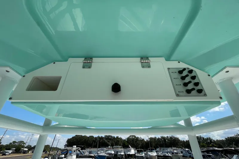 Slide: The Image of 2021 Clearwater 2200 boat console with accessory switches and storage compartment. - 16
