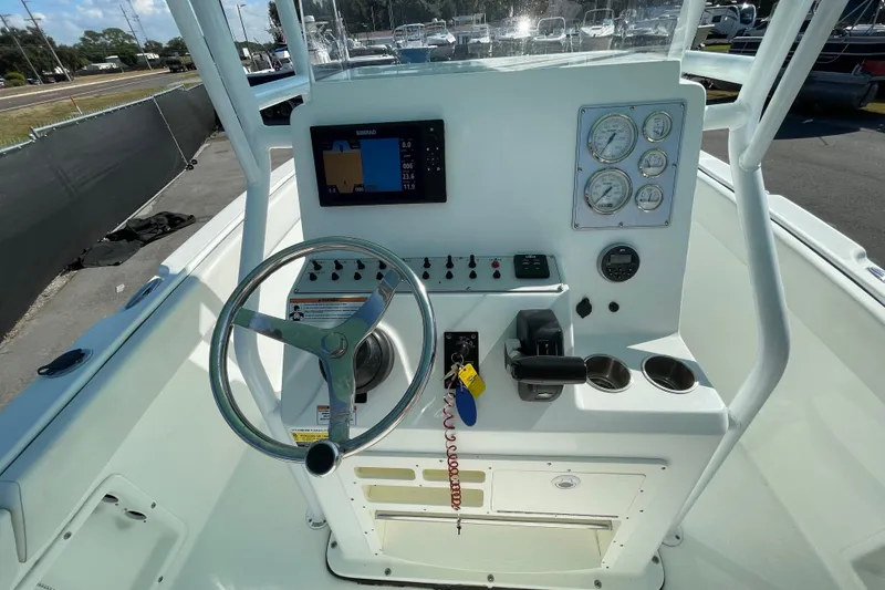 Slide: The Image of Clearwater 2200 boat dashboard, 2021 model, featuring steering wheel, gauges, and navigation display. - 17