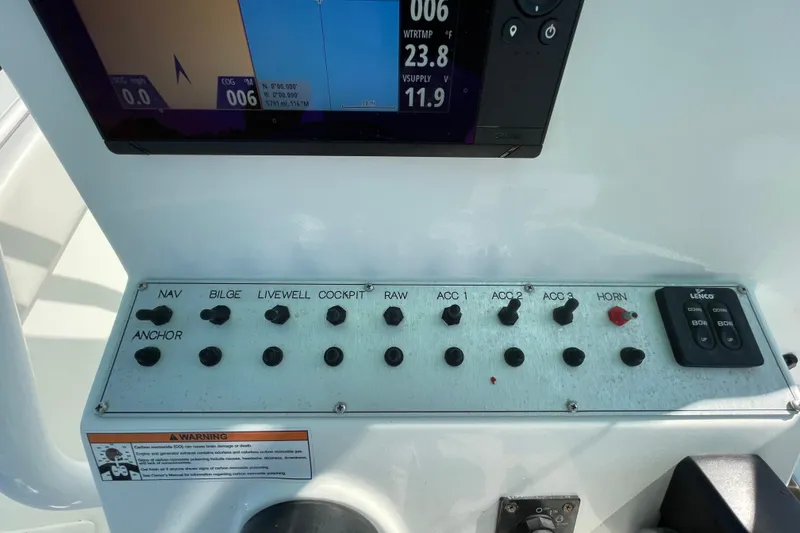 Slide: The Image of Control panel of a 2021 Clearwater 2200 boat with navigation and accessory switches. - 21