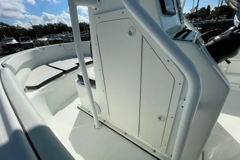 Slide: The Image of 2021 Clearwater 2200 boat interior with seating and control panel under sunny skies. - 23