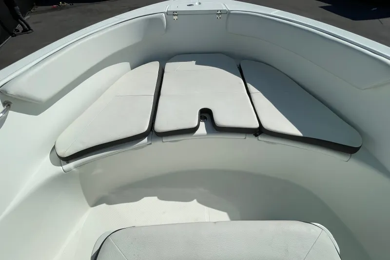 Slide: The Image of 2021 Clearwater 2200 boat interior with cushioned seating in white. - 25