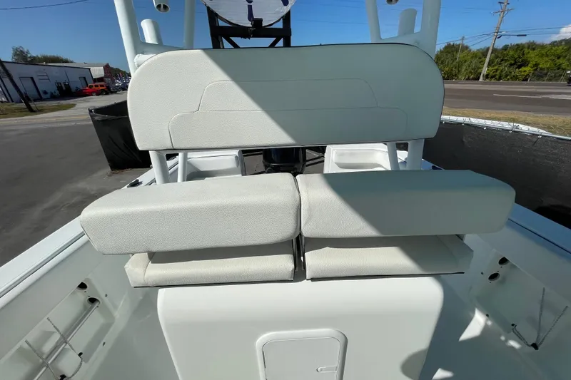 Slide: The Image of 2021 Clearwater 2200 boat with white cushioned seating and sleek design. - 30