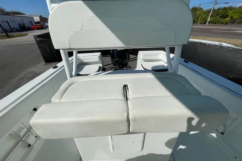 Slide: The Image of 2021 Clearwater 2200 boat interior with white cushioned seating and console. - 31