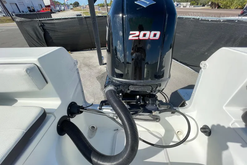 Slide: The Image of 2021 Clearwater 2200 boat with powerful 200 HP outboard motor, docked outdoors. - 33