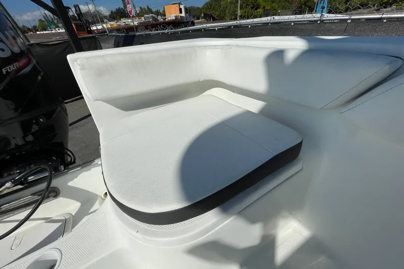 Slide: The Image of White seating area on a 2021 Clearwater 2200 boat, with engine visible. - 37