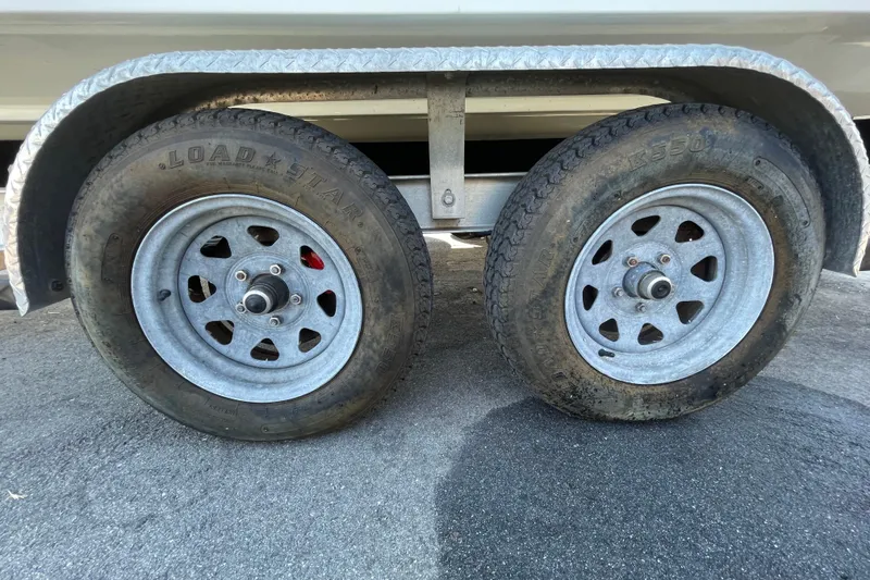 Slide: The Image of Trailer wheels of a 2021 Clearwater 2200 on asphalt surface. - 39